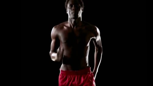 Muscular Man Jogging on Black Background