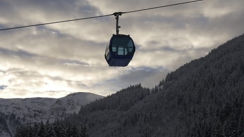 Cable Car Ascending Snowy Mountain in Winter