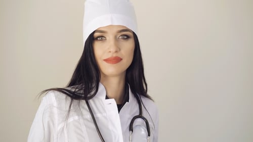 Smiling Woman Doctor in White Lab Coat