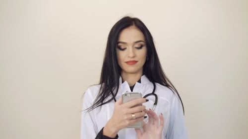 Female Doctor Using Mobile Phone