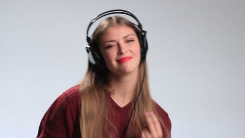 Woman with Headphones Dancing to Music