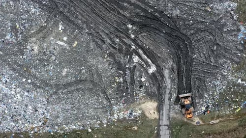 Aerial View of Vast Landfill with Heavy Equipment