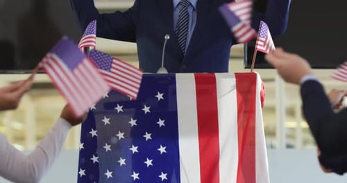Man Celebrating Victory at Podium With American Flags