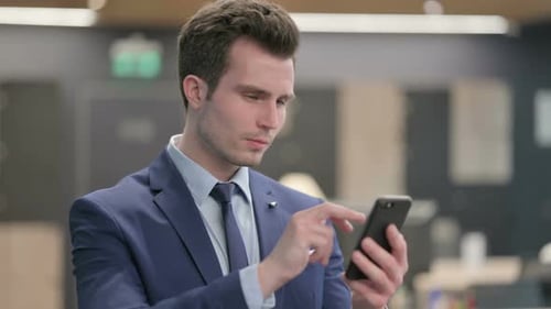 Young Adult Using Phone Indoors