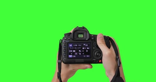 Man photographer is taking photos with professional digital camera. Keyed chroma key