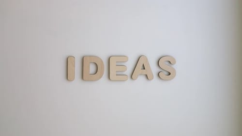 Ideas Spelled Out with Wooden Letters in Timelapse