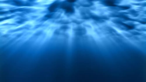 Underwater Light Rays Shine Bright Underneath Rippling Ocean Waves - 4K