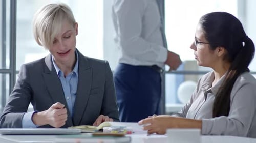 Business Ladies Talking at Office Desk
