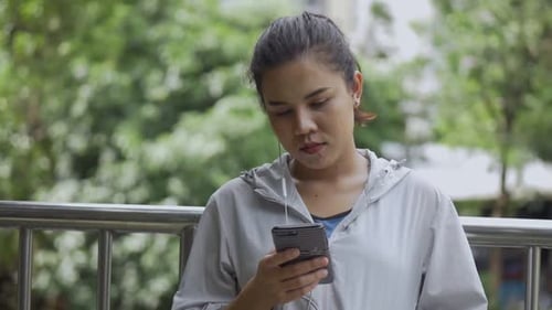 Woman Using Smartphone in Urban Outdoor Setting