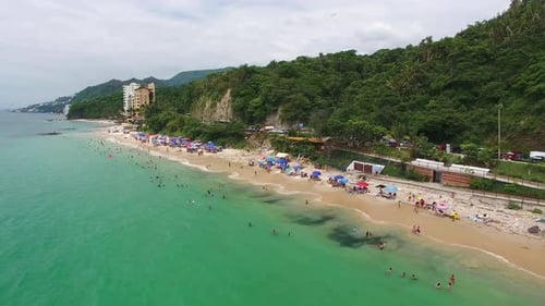 Scenic Aerial View of Tropical Beach with Swimmers