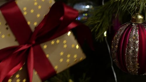 Christmas Gift Under Decorated Tree at Night