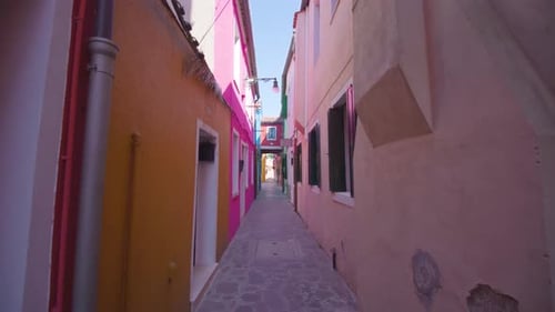 Narrow Lane Between Multicolored Houses Leading to Street