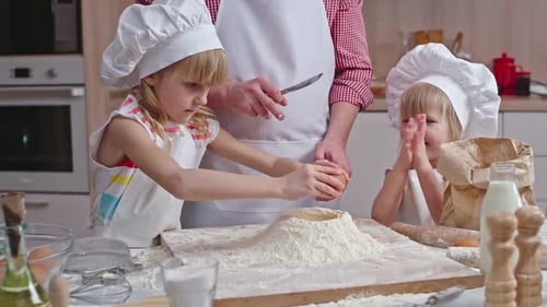 Children Baking Together in Kitchen with Adult