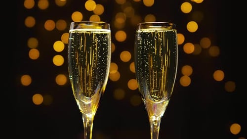 Champagne Glasses Bubbles and Golden Light