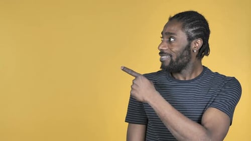Man Points to Left with a Smile