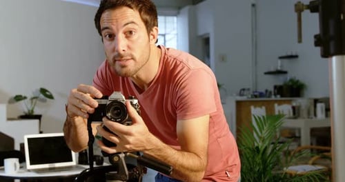 Young Man Explains Photography Concepts with Analog Camera