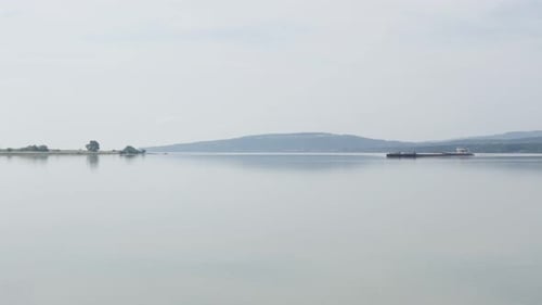 Huge cargo ship on river Danube border of Serbia and Romania 4K 2160p 30fps UltraHD tilting footage
