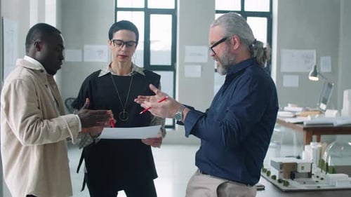 Multiethnic Team of Architects Discussing Business Project