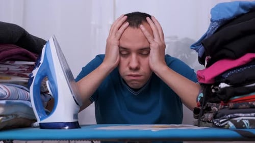 Man Stressed About Ironing Clothes at Home