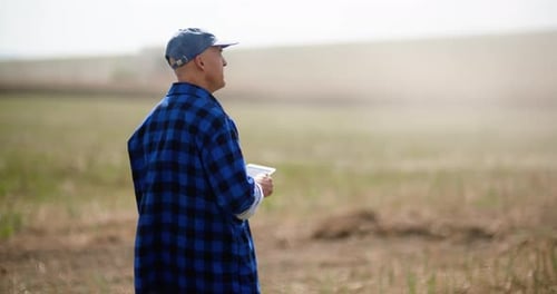 Man Using Tablet in Rural Agricultural Field