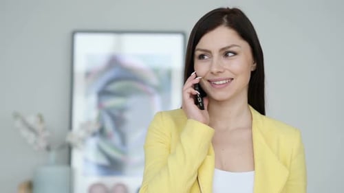Woman in Blazer Talks on Phone Smiling