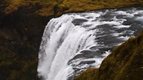 Powerful Waterfall Cascading Through a Mossy Green Landscape