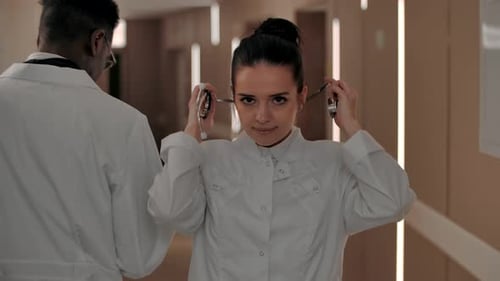 Portrait of a Beautiful Young Female Surgeon in the Corridor of the Hospital