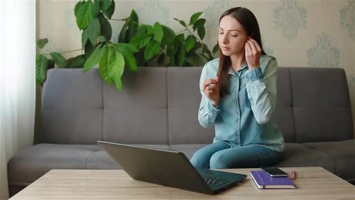 Woman Working at Home on Laptop Talking