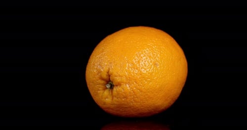 Vibrant Orange Rotating Slowly on Black Background