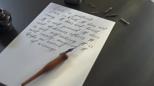 Calligraphy Pen Writing Love Quote on Paper