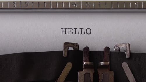 Typing word HELLO on retro typewriter. Close up.