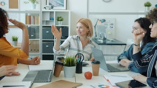 Diverse Women Collaborating in Modern Office Meeting