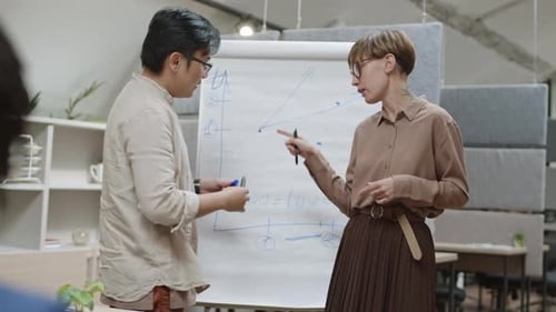 Business Meeting and Data Presentation in Modern Office