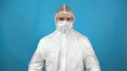 Man in Hazmat Suit Removes Mask, Thumbs Up