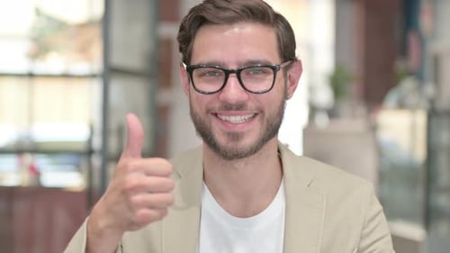 Man Smiling Giving Thumbs Up Indoors