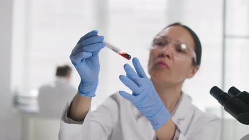 Scientist Holding Blood Sample in Test Tube