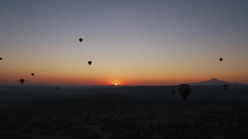 Hot Air Balloons Over Landscape at Sunrise