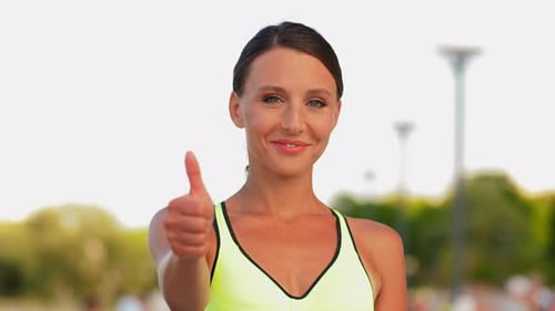 Beautiful Woman Smiles and Gives Thumbs Up