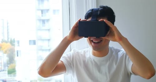 Man Experiencing Virtual Reality in Apartment