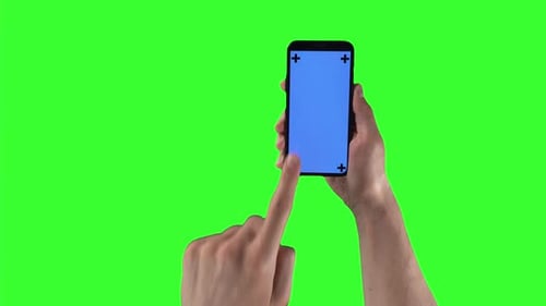 Man with Smartphone in Right Hand Taps and Swiping on Display with Tracking Markers on Greenscreen