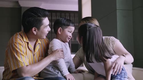 Happy Family Talking and Smiling Indoors