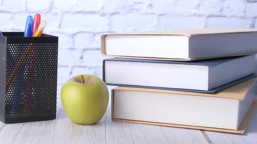 Black To School Concept with Apple on Notepad on Table.