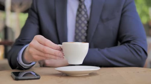 Close Up of Businessman Drinking Coffee