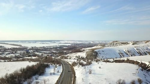 A Car Near Village At Winter