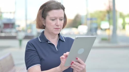 Woman Uses Tablet Device in Urban Setting