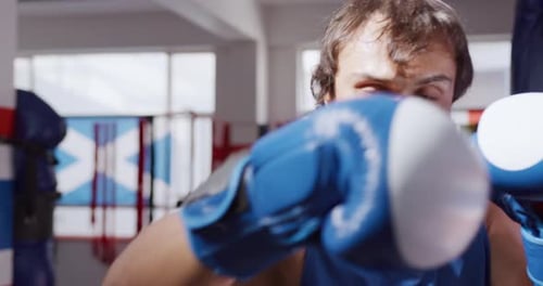Front view of caucasian man working out in boxing gym