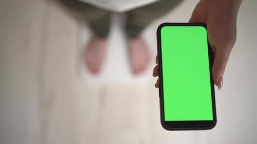 Woman Holding Cellphone with Green Screen