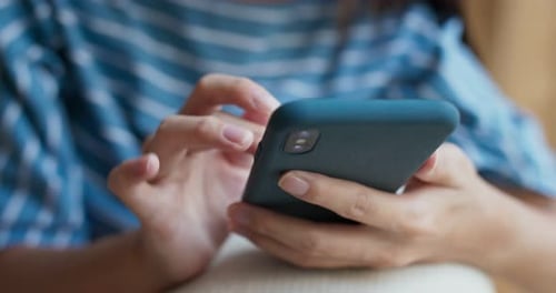 Close up of adult using a smartphone