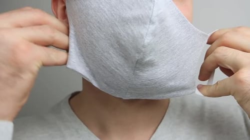 Putting on a Gray Face Mask and Thumbs Up