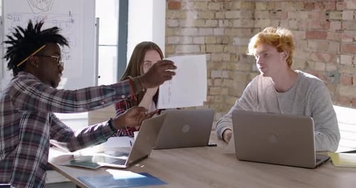 Three Confused Nervous Coworkers Discussing Startup in Office. Portrait of Multiethnic Team Planning
